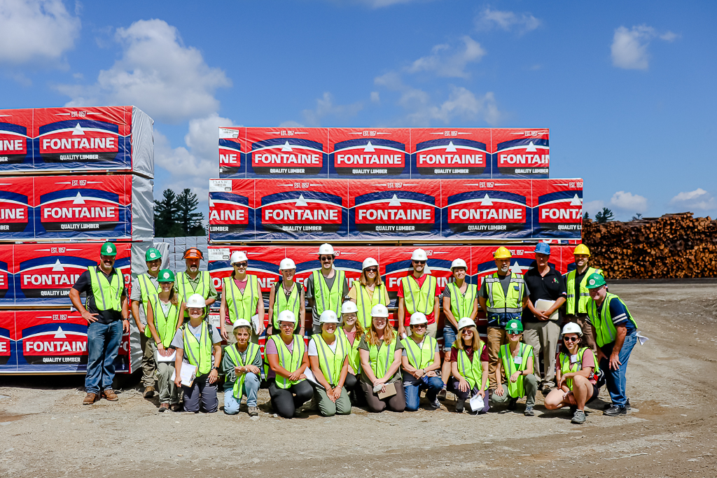 A group photo in front of finished product at Stratton Lumber